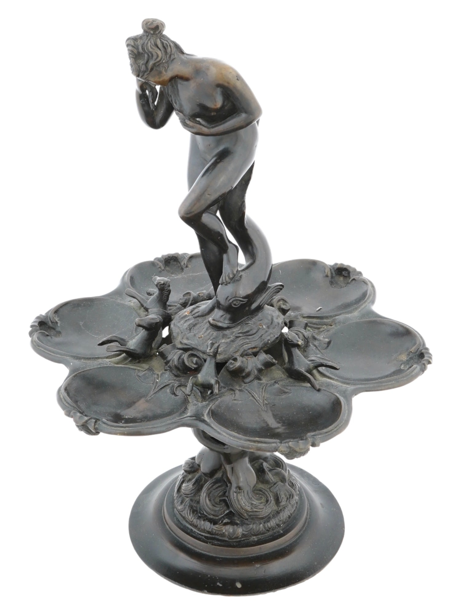 ANTIQUE EUROPEAN ART NOUVEAU BRONZE CANDY DISH: A rare antique European Art Nouveau patinated bronze figural candy dish, modeled with a figure of a nude Venus standing with one foot on a dolphin above a dish with six compartments adorned with relie