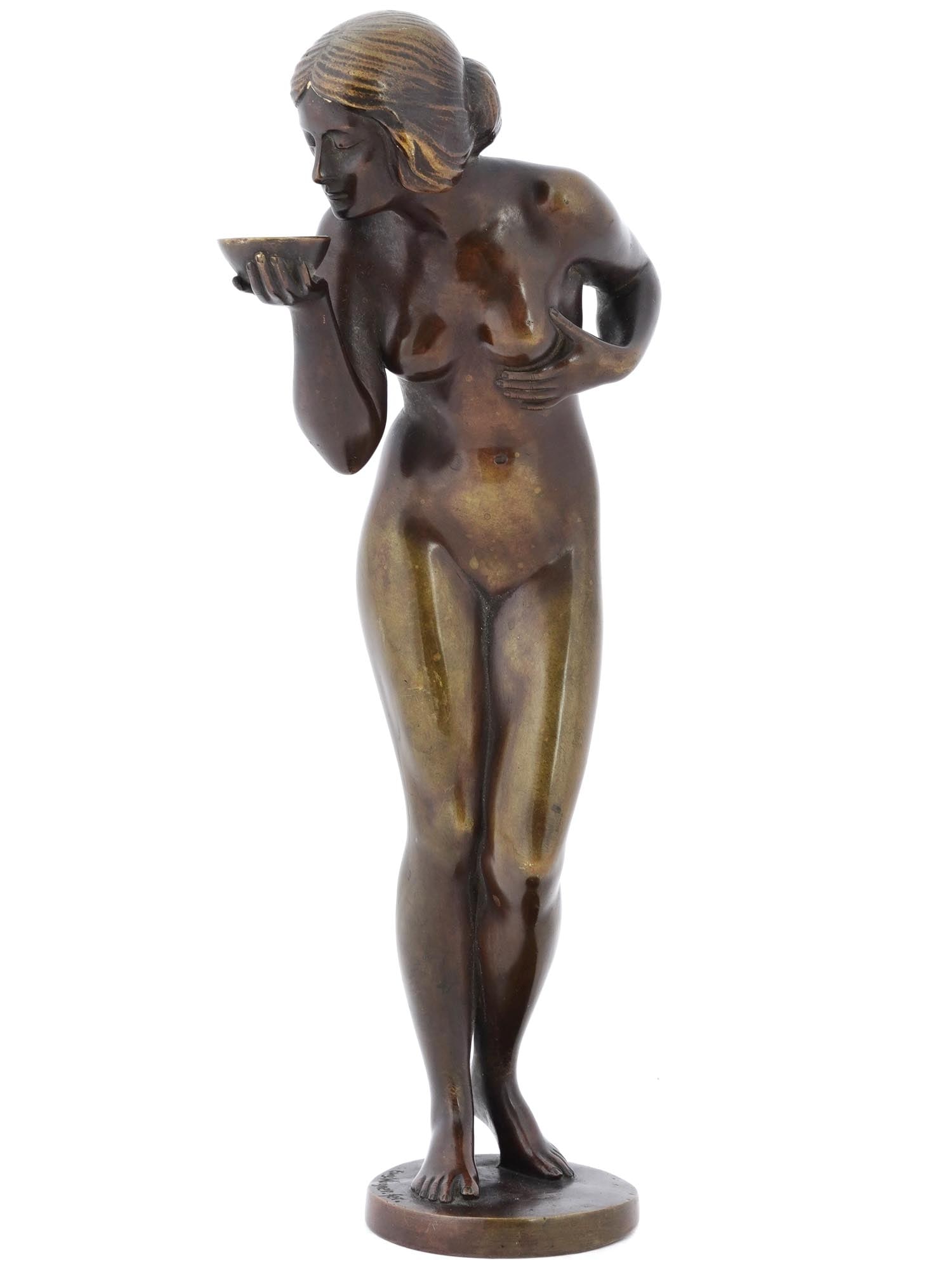 GERMAN WOMAN BRONZE SCULPTURE BY EUGENE WAGNER: Eugene Wagner, German, 1871 to 1942, gold patinated bronze sculpture, The Drinker, depicting a female nude figure holding a cup. Mounted on a round shaped base. Signed, Eug. Wagner fer., on the base. 