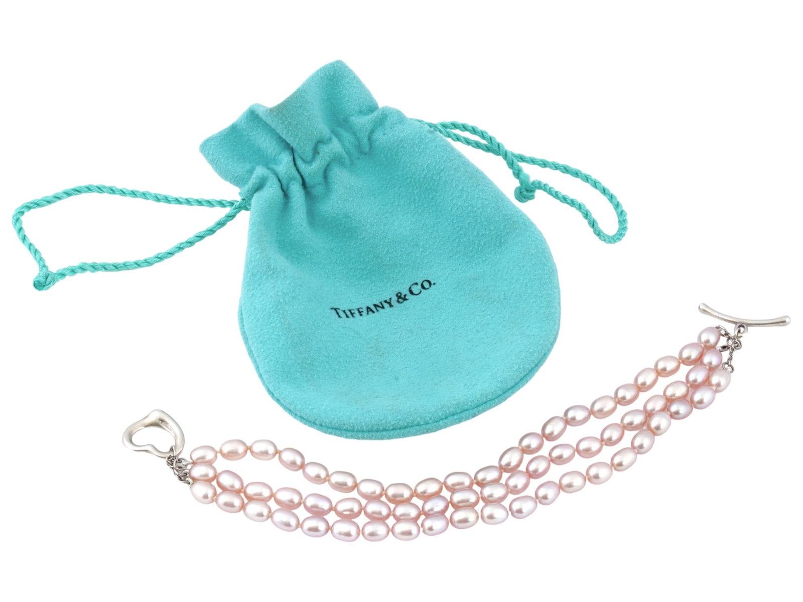 TIFFANY AND CO STERLING PEARLS BY THE YARD BRACELET: A vintage pink freshwater pearl bracelet by Tiffany and Co. Design by Elsa Peretti, 1940 to 2021, an Italian jewelry designer. Pearls by the Yard. The piece is composed of three pearl strings. Sterlin