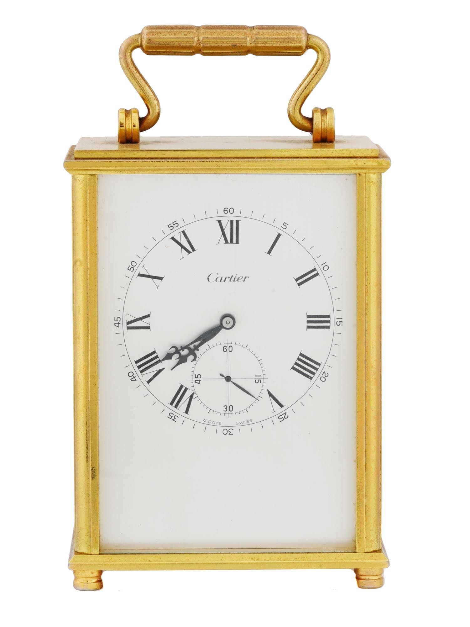 MID CENT CARTIER 8 DAYS GILT BRASS TRAVEL CLOCK: A mid-20th century gilt brass 8 Days travel clock by Cartier. Footed rectangular case with a handle on top. White enamel dial with sub-dial, Arabic and Roman numerals, marked Cartier, 8 Days, Swiss. E