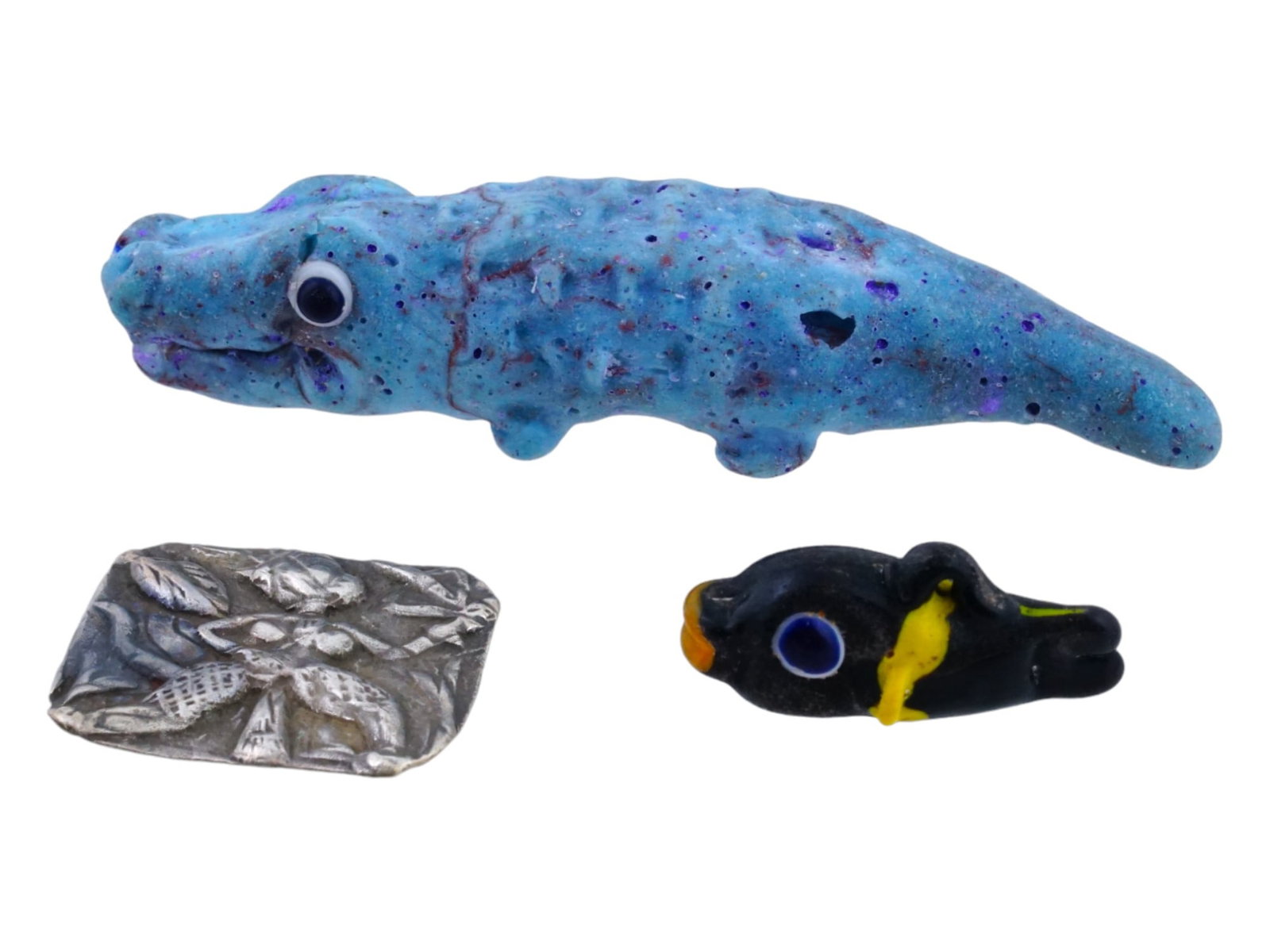 ANCIENT NEAR EAST LEVANT AND EGYPT CARVED AMULETS: A group of ancient Near East carved amulets from the Levant and Egypt, each bearing unique symbolism. Among the treasures are amulets shaped like crocodiles and fish, revered for their protective and 