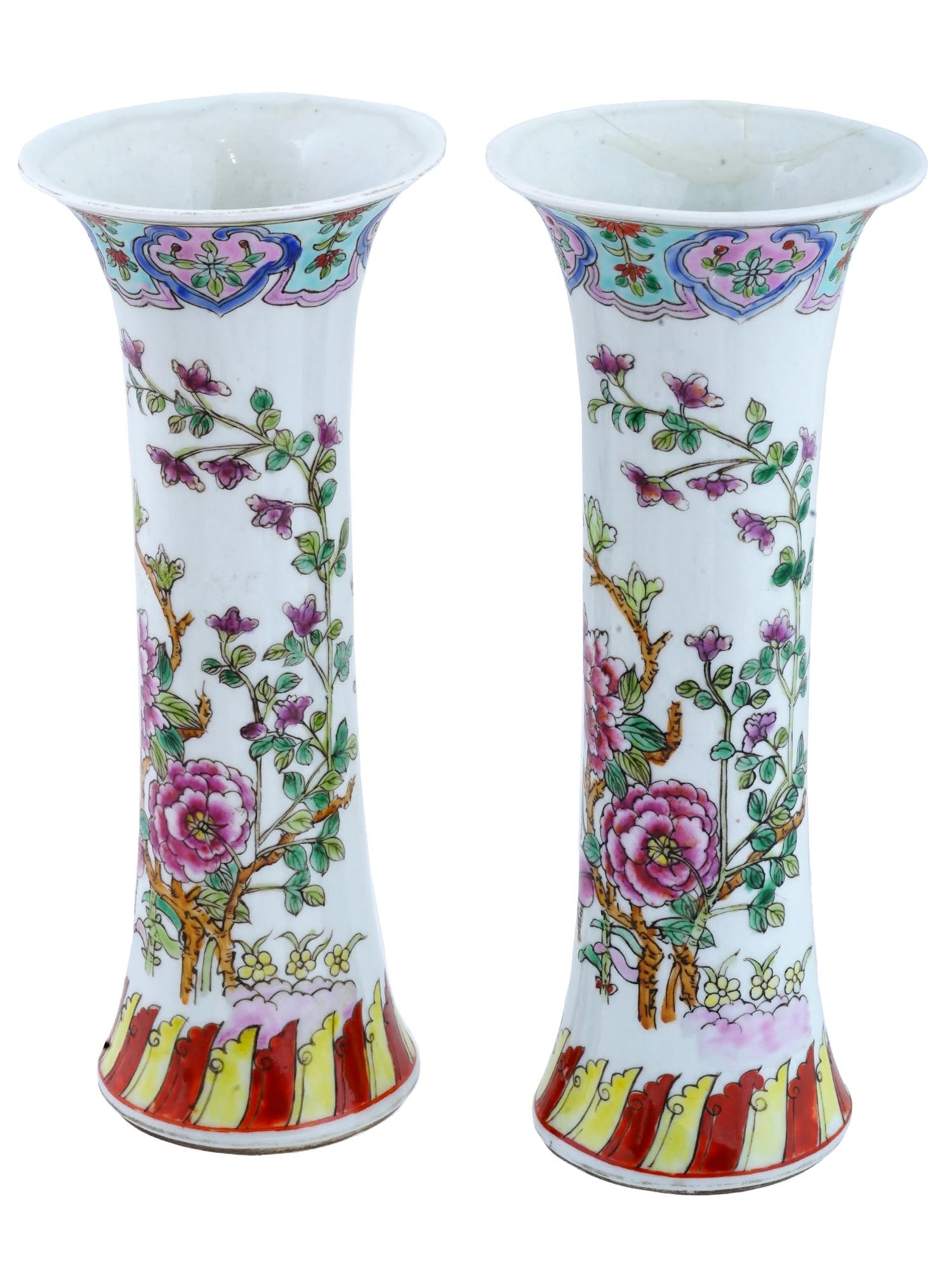 PAIR OF VINTAGE CHINESE REPUBLIC PERIOD PORCELAIN VASES: A pair of vintage Chinese Republic period porcelain vases. The narrow trump shaped vases are adorned with fluted necks and bases, and enameled with polychrome images of blossoming flowers. The necks a