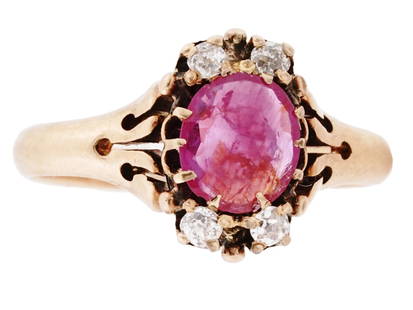 14K GOLD VICTORIAN MANNER DIAMOND PINK SAPPHIRE RING: A vintage 14K Yellow Gold jewelry ring. The ring is made in the late Victorian era design, and adorned with openwork elements. The ring is encrusted with a Pink Sapphire stone in the center