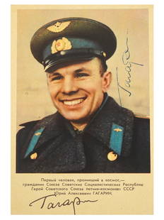 SOVIET ERA ASTRONAUT YURI GAGARIN PHOTO CARD SIGNED: A Russian Soviet era post card with a historical color printed photo depicting a portrait of smiling Soviet pilot astronaut Yuri Gagarin. The photo is signed by Yuri Gagarin, to the center right.