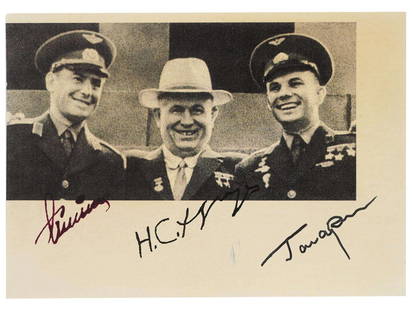 SOVIET PHOTO SIGNED BY GAGARIN TITOV KHRUSHCHEV: A Russian Soviet era black-and-white postcard depicting cosmonauts Yuri Gagarin and German Titov, the first humans to journey into outer space, together with Nikita Khrushchev, the leader of the Sovie