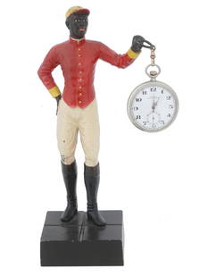 POCKET WATCH AND CAST METAL JOCKEY WATCH STAND: A vintage cast and painted metal pocket watch stand comprising a figurine of a jockey with a Swiss DOXA pocket watch. Circa 1940 to 1970. The gentleman clad in riding gear holding a ring that is conne