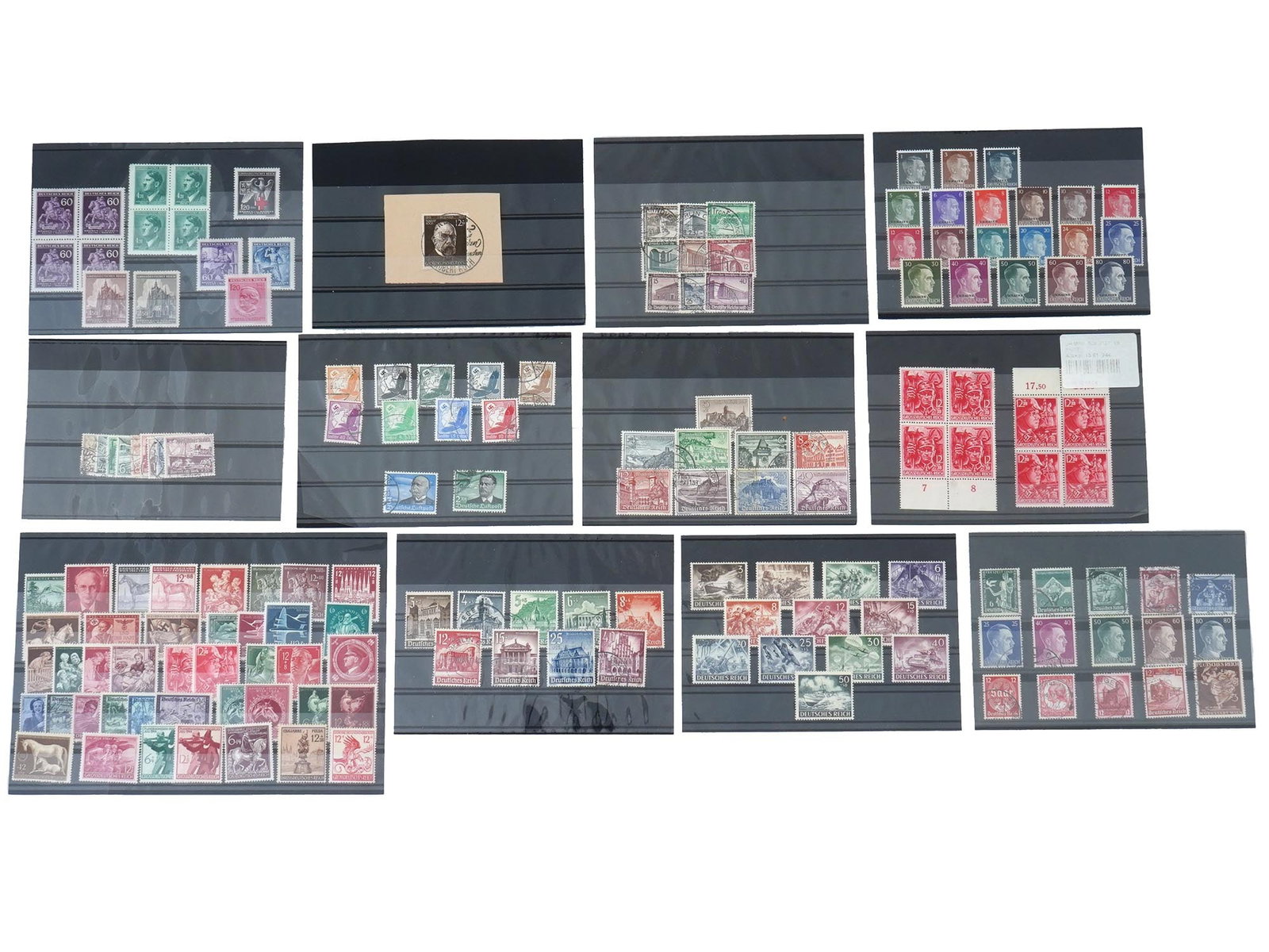 COLLECTION OF NAZI GERMAN THIRD REICH PERIOD STAMPS: A collection of Nazi German Third Reich period stamps spanning 12 boards, encompassing the last stamps of the Reich and those issued for occupied Ukraine. These stamps offer a comprehensive overview o