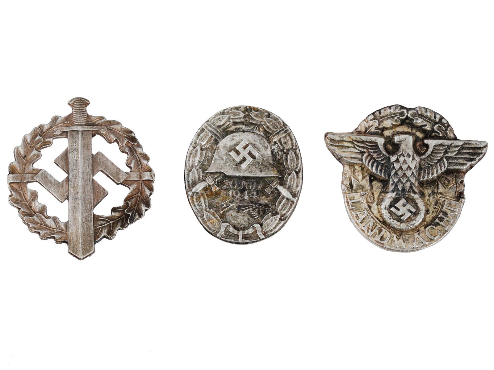 GROUP OF THREE WWII NAZI GERMAN BADGES: A group of three WWII Nazi German badges. An Operation Valkyrie wound badge, marked with the design of a German combat helmet and crossed swords, with the added date of July 20, 1944. An SA sports bad