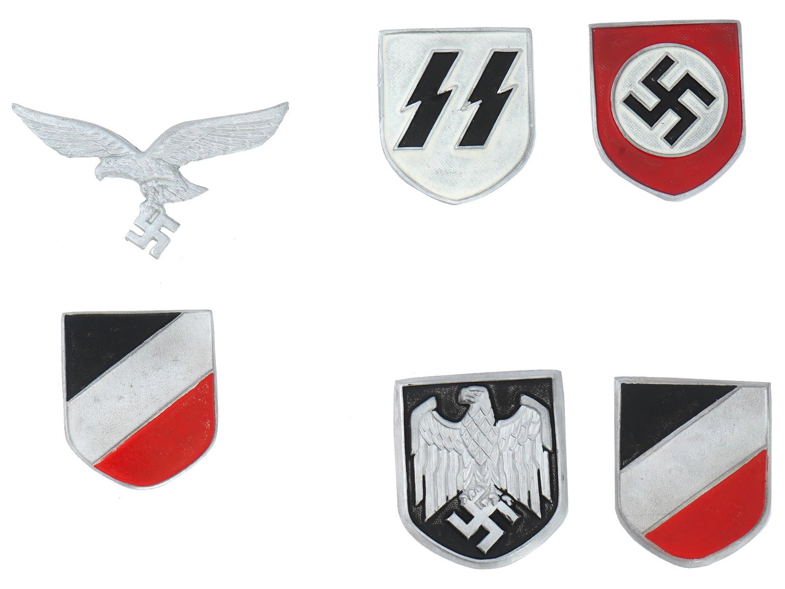 THREE SETS OF SHIELD PINS FOR GERMAN WWII HELMETS: A German WWII three sets of pins for SS, and Luftwaffe helmet shields. There are 6 items in total. Nazi eagles with a swastika in their talons, flags, an SS insignia in the form of two lightning bolts