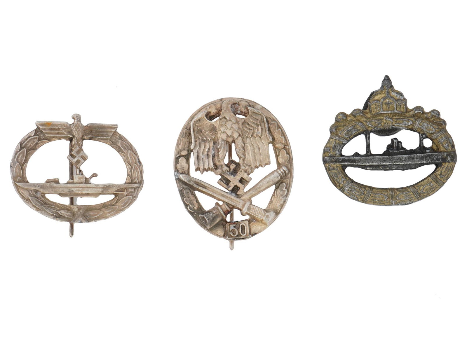 GROUP OF WWI AND WWII NAZI GERMAN MILITARY BADGES: A group of two WWII Nazi German military badges. The U-Boat badge, featuring a submarine within a wreath, with the Nazi eagle clutching a swastika on top. Additionally, the Army General Assault badge,
