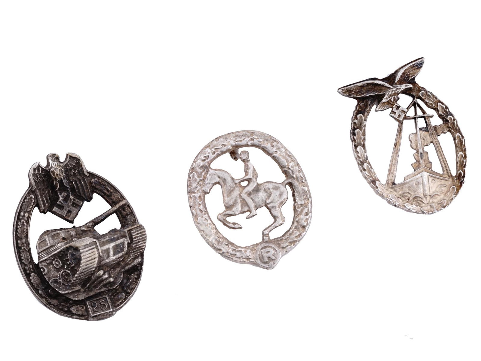 GROUP OF THREE WWII NAZI GERMAN BADGES: A group of three WWII Nazi German badges including a Panzer Badge for 25 engagements consisting of a three quarters front image of a Panzer IV tank, surrounded by an oak wreath and surmounted by the W