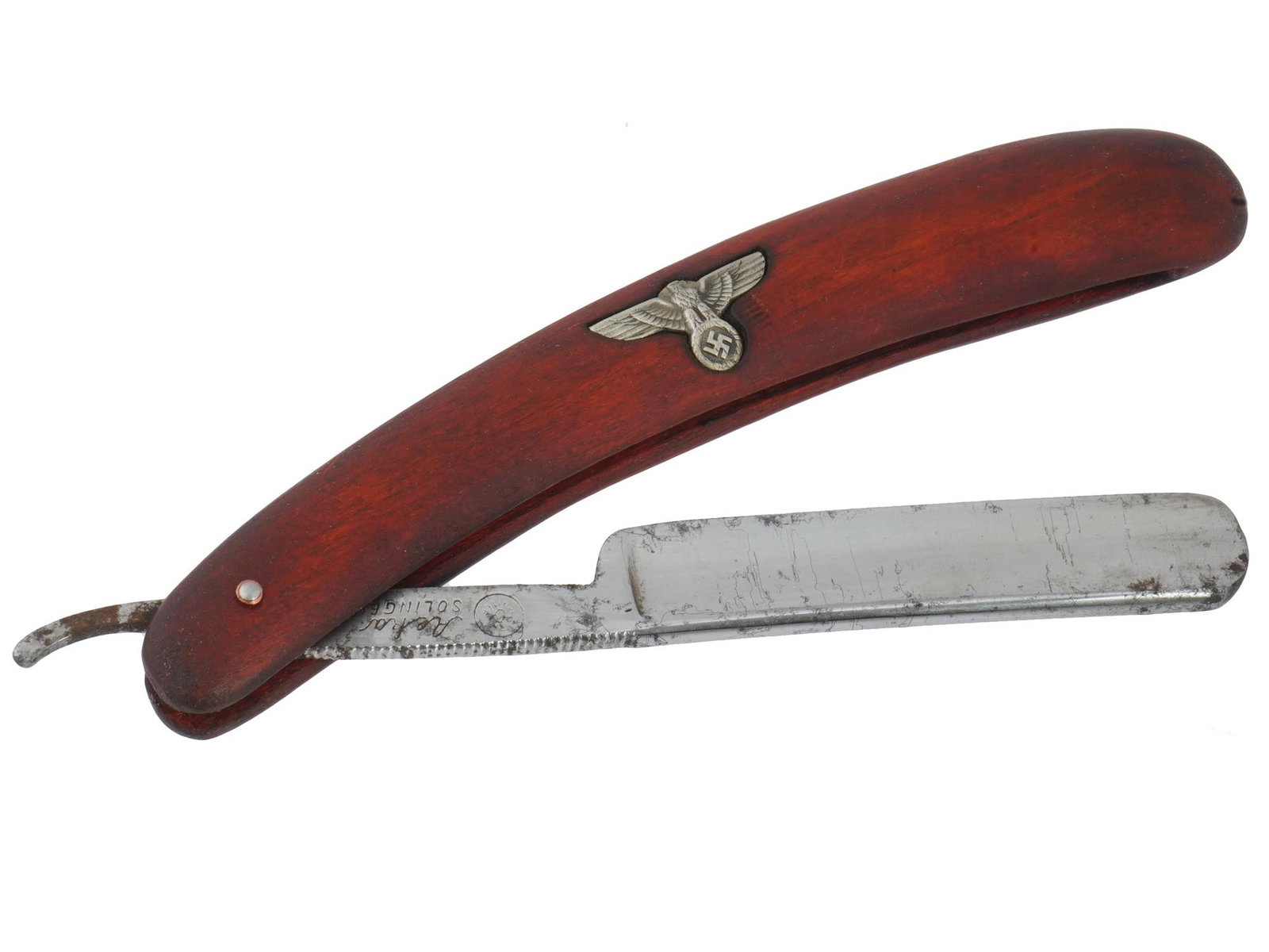 GERMAN WWII NSDAP OFFICIALS STRAIGHT SHAVING RAZOR: A WWII Nazi German Third Reich NSDAP straight shaving razor. The handle is adorned with a Synthetic base, adorned with an overlay depicting the Third Reich eagle with swastika insignia in its claws, t