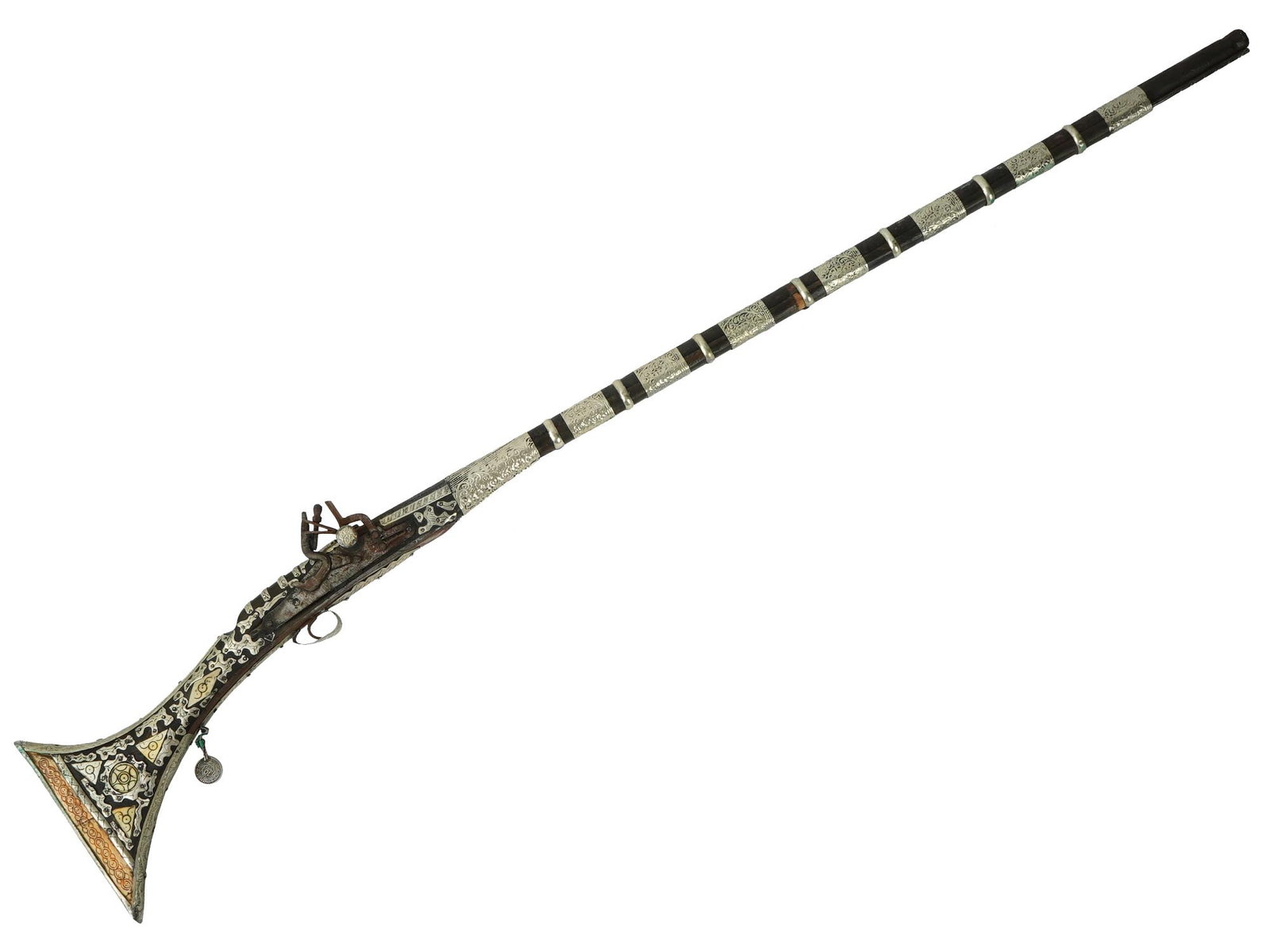 VINTAGE WALL DECORATION MUKALA FLINTLOCK GUN: A vintage wall decoration in the shape of an Arabian Mukala flintlock gun, produced in the Maghreb, North African countries in the 19th century. The rifle has an elongated, thin shape and is richly de