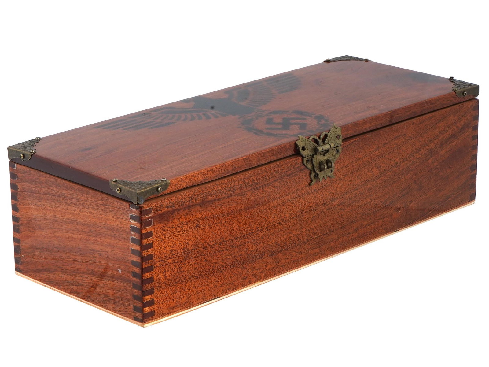 GERMAN WWII WOODEN BOX WITH REICHSADLER: A German WWII wooden box with Reichsadler. A wooden box of an elongated rectangular shape with a butterfly shaped brass lock. On the lid is an image of the Reichsadler, the coat of arms of Nazi German