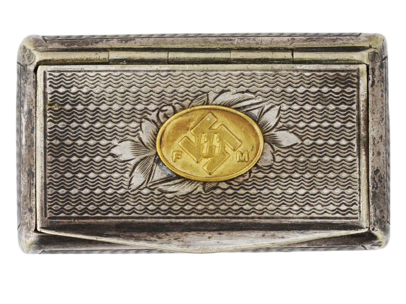 GERMAN WWII SS TOTENKOPF MINIATURE TRINKET BOX: A WWII German SS Totenkopf miniature lidded trinket box. The convex rectangular box with a wavy pattern on the surface on all sides. The hinged lid features a raised floral design in the center and an