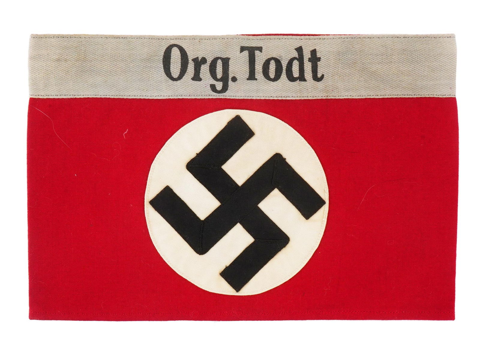 WWII NAZI GERMAN ORGANIZATION TODT ARMBAND: A WWII Nazi German Organization Todt armband. Features a white roundel with a stitched-on swastika on red fabric, along with the inscription Org. Todt sewn on top. The Organization Todt was a Nazi civ