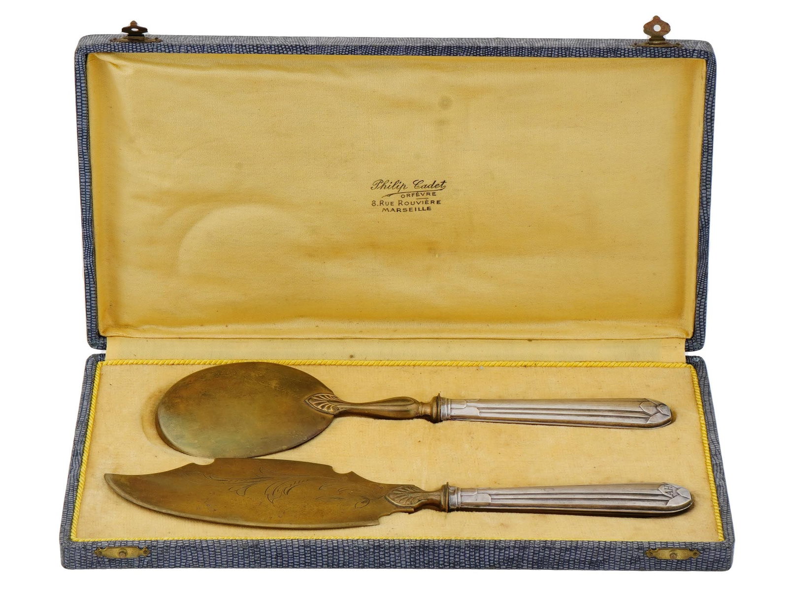 WWII SILVER DESSERT CUTLERY SET OF ADOLF HITLER: A World War II French dessert cutlery set with sterling silver handles. A total of 2 items, an ice cream knife and server. Gilt main parts with etched decor. The handles have engraved initials AH, pre