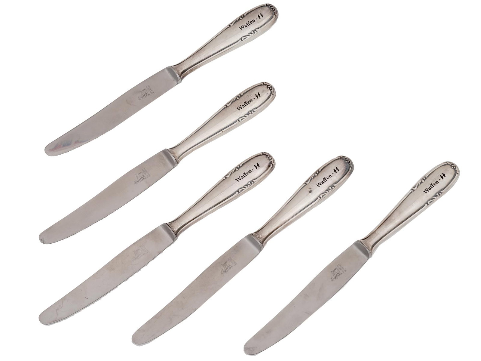SET OF 5 GERMAN WWII WAFFEN SS TABLE KNIVES: A set of five WWII Nazi German silver plated table knives from a Waffen SS officers canteen. All pieces are decorated with Waffen SS runes on the handles. Each handle is adorned with an engraved scrol