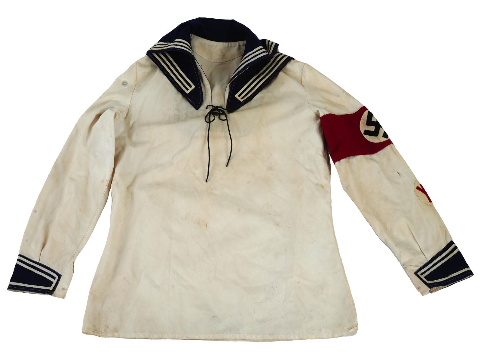 WWII NAZI GERMAN WHITE KRIEGSMARINE UNIFORM SHIRT: A WWII Nazi German Kriegsmarine white uniform shirt featuring a central vertical, V-neck slash opening and an integral fold back blue nankeen rectangular collar. Comes with a red sleeve patch with a s