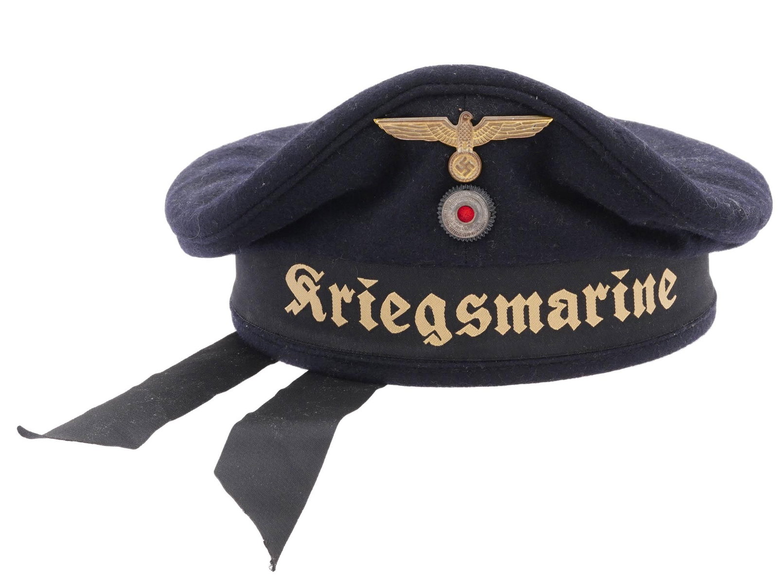 GERMAN WWII KRIEGSMARINE DONALD DUCK HAT: A WWII Nazi German Kriegsmarine ?Donald Duck? cap featuring a blue silk top and embroidered with the title Kriegsmarine in yellow thread. The tally is affixed by braided threads in three places and a 