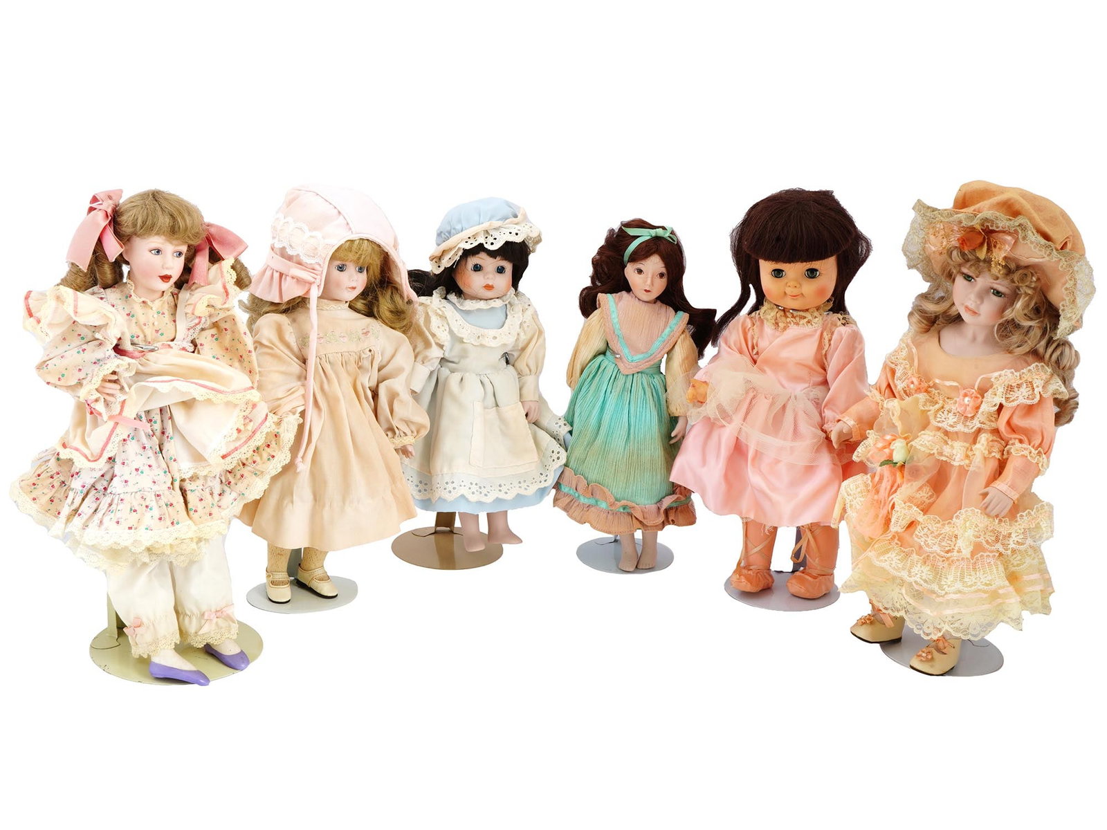 COLLECTION OF VINTAGE PORCELAIN DOLLS IN OUTFITS: A collection of vintage dolls, featuring a variety of shapes and sizes, each adorned with bouffant hairstyles and dressed in exquisite outfits. These dolls, with their distinctive bouffant hairstyles,