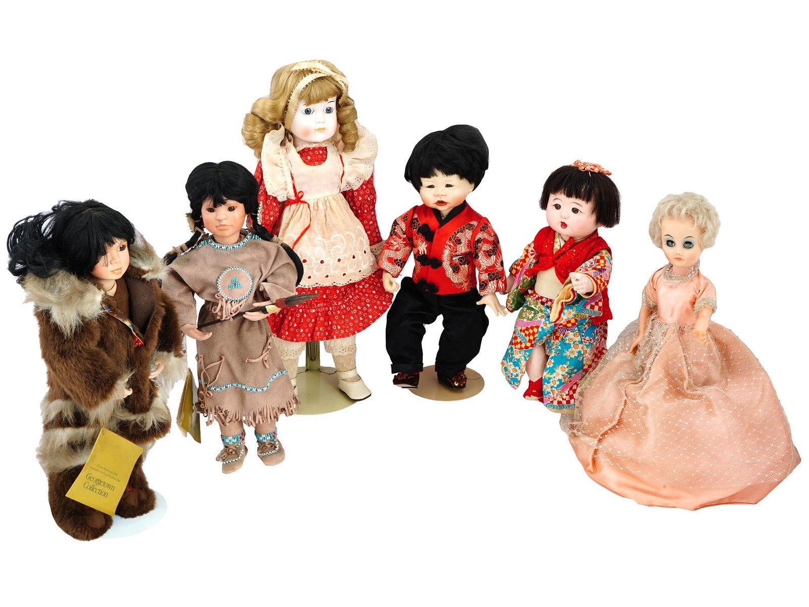 COLLECTION OF VINTAGE PORCELAIN DOLLS IN OUTFITS: A collection of vintage dolls, featuring a variety of shapes and sizes, each adorned with bouffant hairstyles and dressed in exquisite outfits. These dolls, with their distinctive bouffant hairstyles,