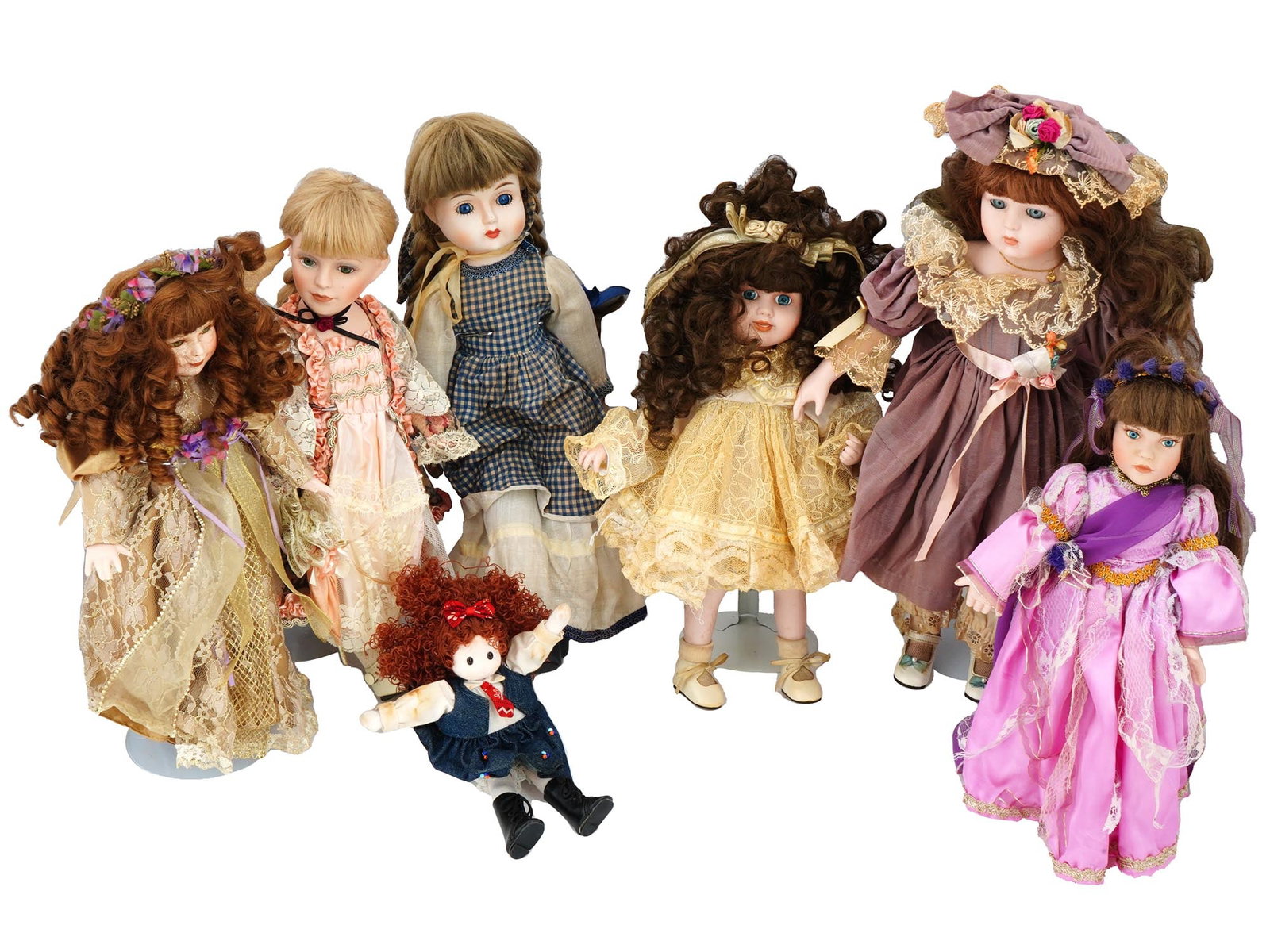 COLLECTION OF VINTAGE PORCELAIN DOLLS IN OUTFITS: A collection of vintage dolls, featuring a variety of shapes and sizes, each adorned with bouffant hairstyles and dressed in exquisite outfits. These dolls, with their distinctive bouffant hairstyles,
