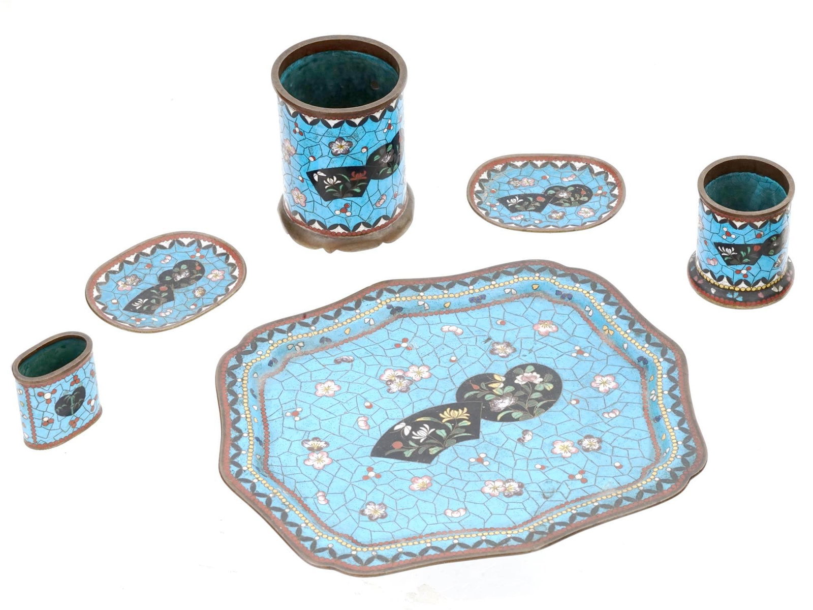 ANTIQUE JAPANESE MEIJI PERIOD CLOISONNE PIECES: A group of six antique Japanese Meiji period cloisonne pieces with floral patterns, including trays and stands of various shapes and sizes. Cloisonne is a traditional Japanese enamelwork technique kno