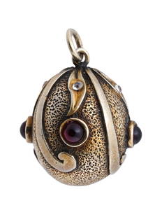 RUSSIAN STERLING RUBY STONE DIAMONDS EGG PENDANT: A Russian gilt Sterling Silver Easter egg pendant. The exterior of the pendant is adorned with a relief scrollwork design, and encrusted with Ruby stones and Diamonds. Marked with a 925 Sterling Silve