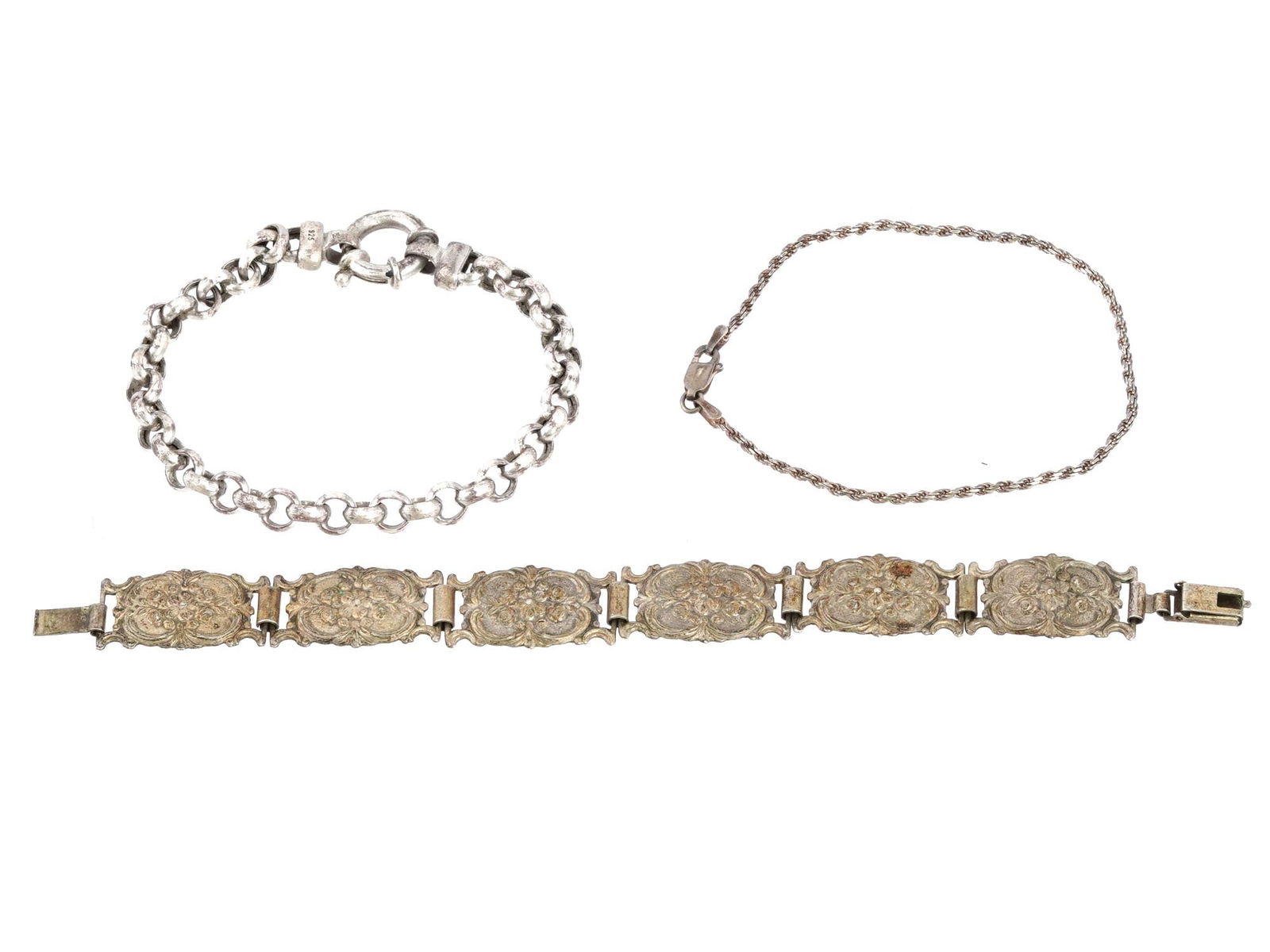 THREE VINTAGE SILVER CHAIN AND PLAQUE BRACELETS: A group of three silver bracelets, each offering a distinct design to cater to diverse preferences. The assortment includes elegant chain bracelets, which provide a timeless and versatile accessory su