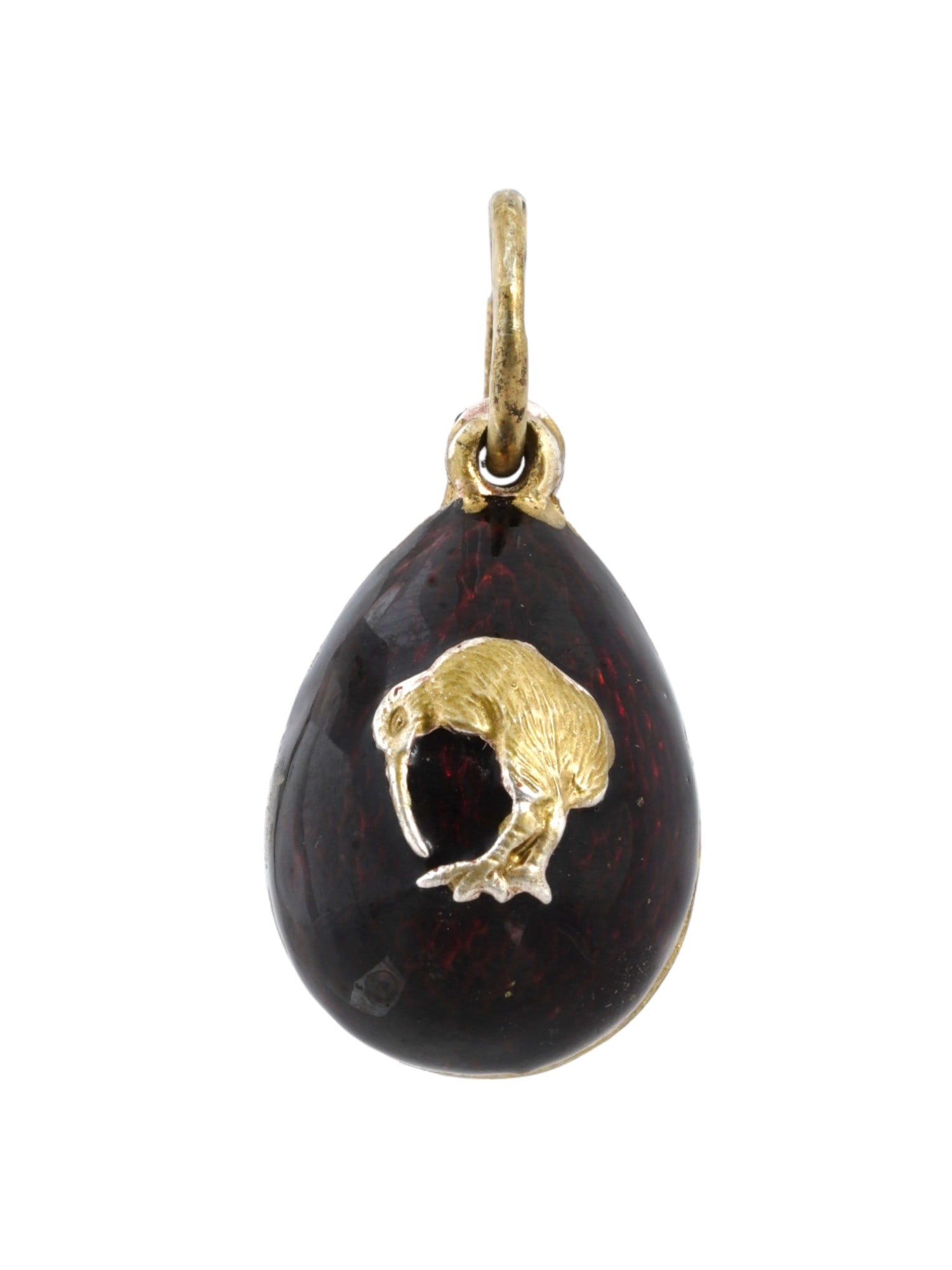 RUSSIAN GILT SILVER GUILLOCHE ENAMEL EGG PENDANT: A Russian gilt silver egg-shaped pendant. Oxblood red and purple guilloche enamel surface. Kiwi brid overlay on the obverse. Hallmark of 88 silver standard and makers mark are on the fitting ring. Tot