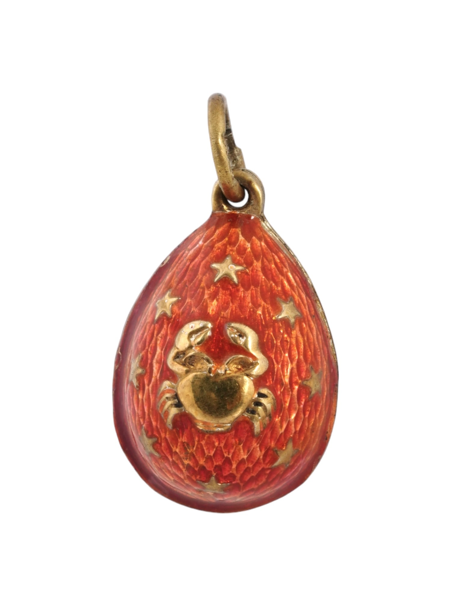 RUSSIAN GILT SILVER GUILLOCHE ENAMEL EGG PENDANT: A Russian gilt silver egg-shaped pendant. Red guilloche enamel surface. Cancer zodiac sign and stars overlay on both sides. Hallmark of 84 silver standard and makers mark are on the fitting ring. Tota