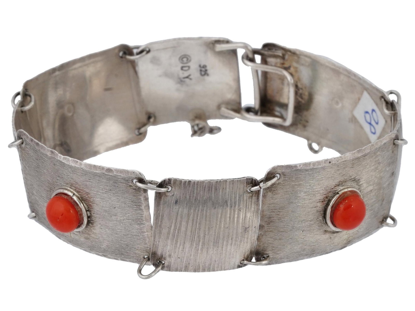 DAVID YURMAN STERLING SILVER CARNELIAN LINK BRACELET: A sterling silver link bracelet by David Yurman. Wide rectangular links of various size with relief surface, set with red carnelian cabochons. Hook clasp with safety chain. Hallmark D.Y., 925 is on th
