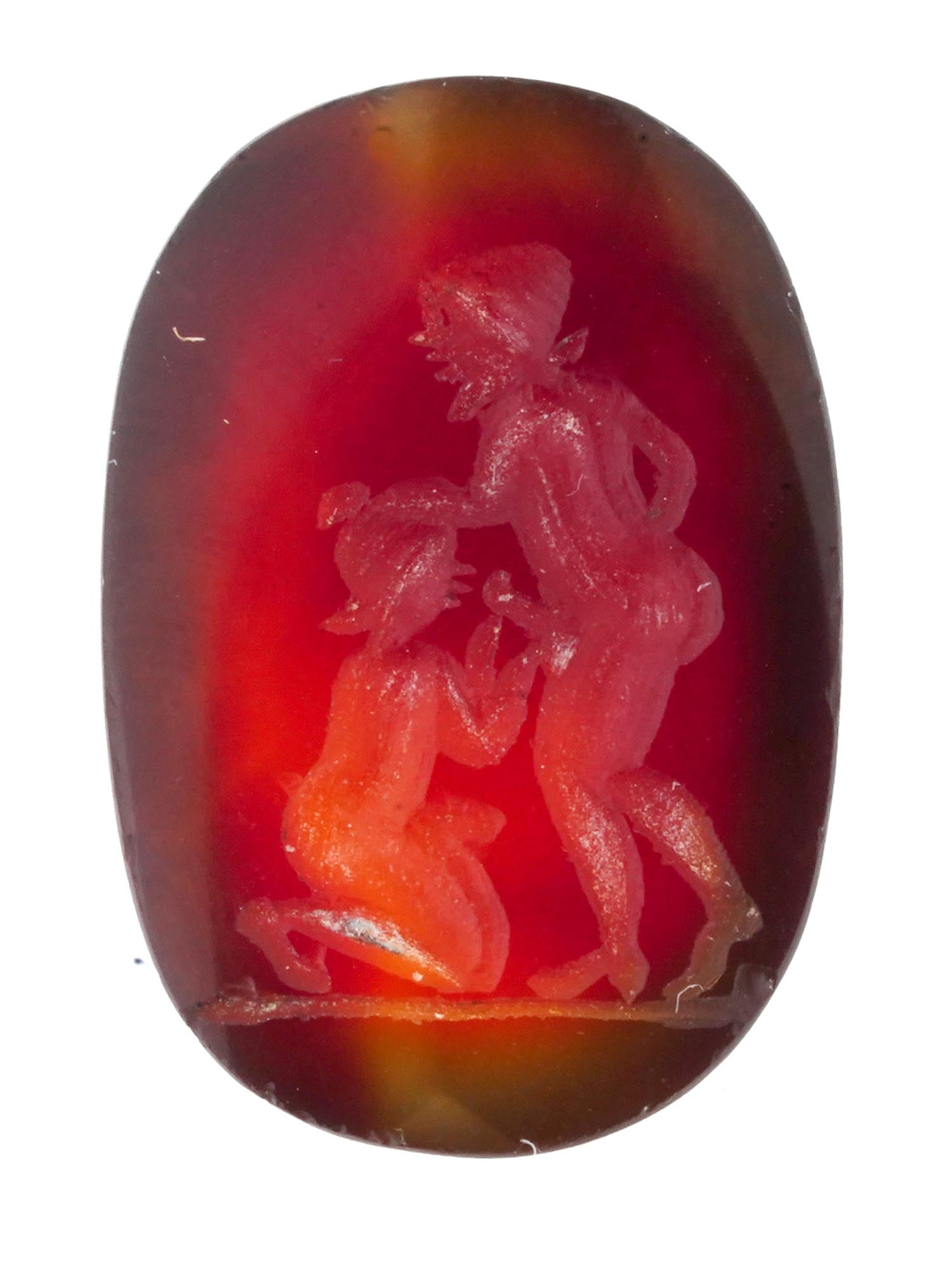 ROMAN INTAGLIO CAMEO CARNELIAN STONE W EROTIC SCENE: An ancient Roman Intaglio cameo on Carnelian stone with a carved erotic scene. Circa 2nd to 3rd centuries AD. Oval in shape, brown to honey in color, smooth edge. The reverse side is flat. An erotic s