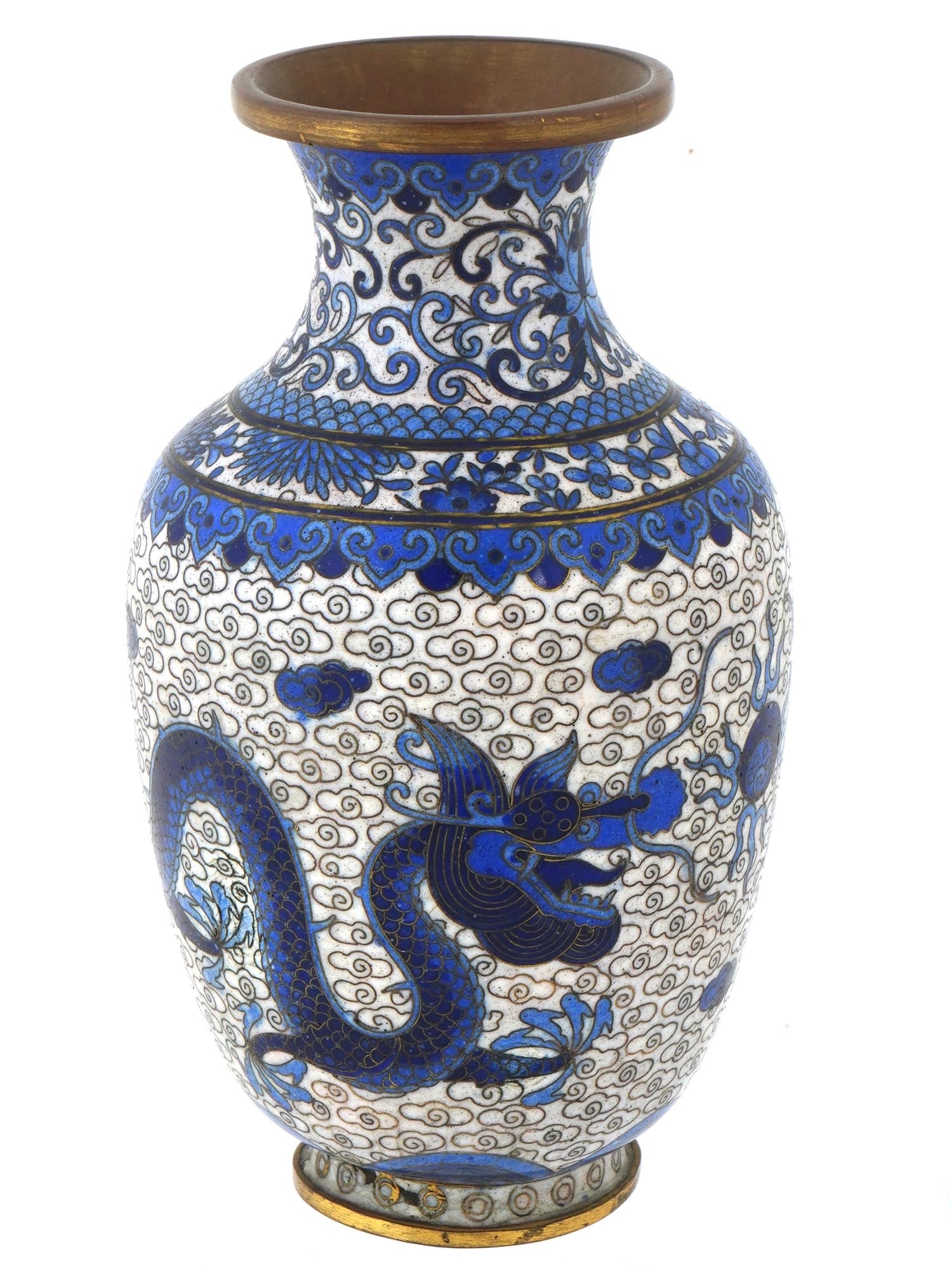 CHINESE DRAGON BLUE AND WHITE CLOISONNE ENAMEL VASE: A Chinese blue and white enamel vase. The vase has an urn shaped body and a fluted neck. The exterior of the ware is enameled with a symmetrical image of dragons surrounded by a cloud motif. The neck 
