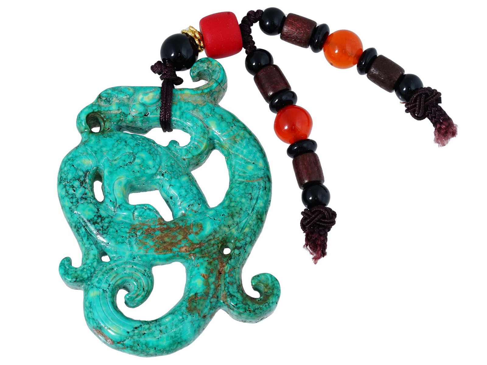 ANTIQUE CHINESE GRIFFIN CARVED JADE AMULET PENDANT: An antique Chinese late Qing Dynasty figural amulet pendant hand carved of turquoise patinated Jade, most likely Hotan or Hetian. The pendant depicts a griffin, engraved with detailed patterns and dec