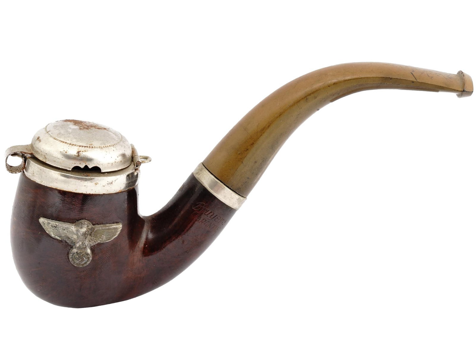 WWII GERMAN NAZI BRUYERE WOOD SMOKING PIPE.: A WWII Nazi German Third Reich Bruyere Garantie wooden smoking pipe. The smoking pipe is adorned with a hinged metal wind cap and a metal eagle swastika insignia plaque on the side. Marked, Bruyere Ga