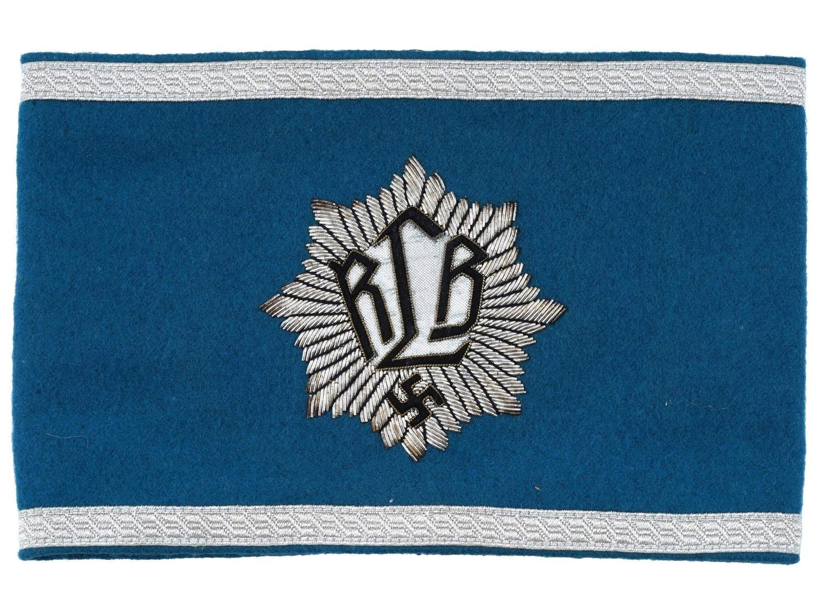 GERMAN WWII TYPE RLB LEADER ARMBAND: A WWII Nazi German Third Reich type RLB leader armband. Made of light blue felt with silver thread embroidery, features a Swastika emblem and inscribed RLB in the center. The Reichsluftschutzbund RLB,