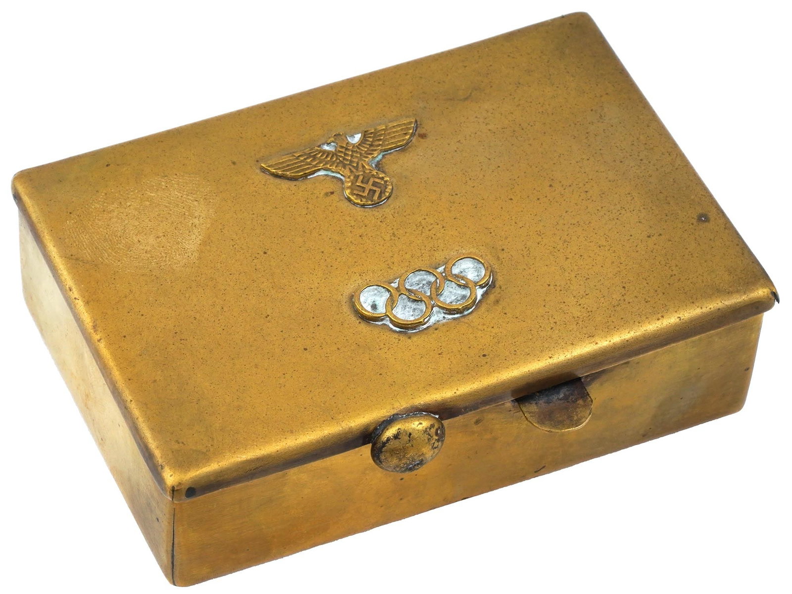1936 WWII NAZI GERMAN OLYMPIC BRASS CIGARETTE CASE: A 1936 WWII Nazi German era Olympic brass cigarette case. The cover of the case is adorned with a relief design depicting a Nazi eagle clutching a swastika insignia and five Olympic rings. Second Worl