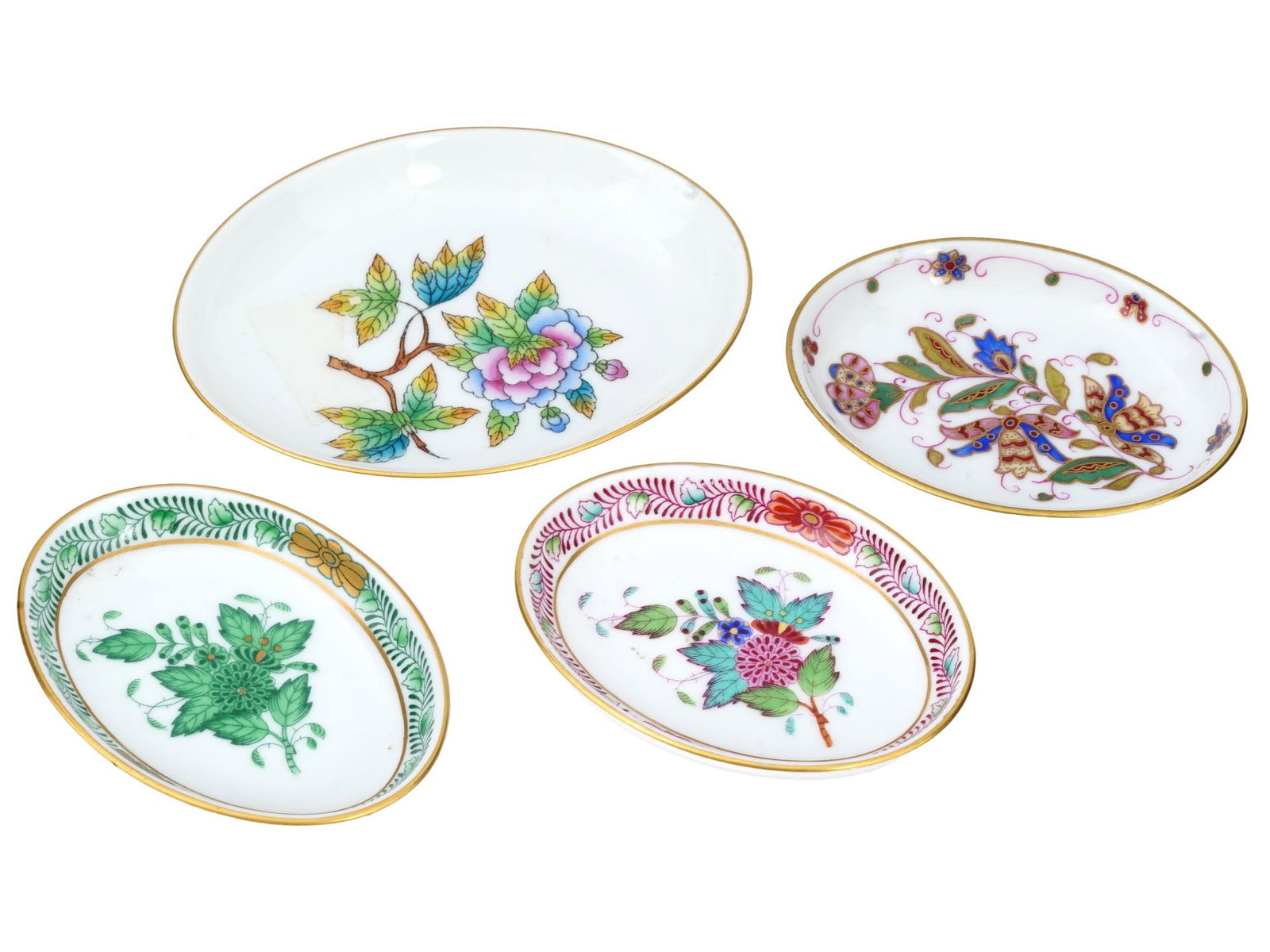HUNGARIAN MINIATURE PORCELAIN PLATES BY HEREND: A lot of four Hungarian miniature porcelain plates by Herend. All oval shaped plates are hand painted, with floral designs and gilded edges. On the back of each item, there is a clear Herend Hungary m