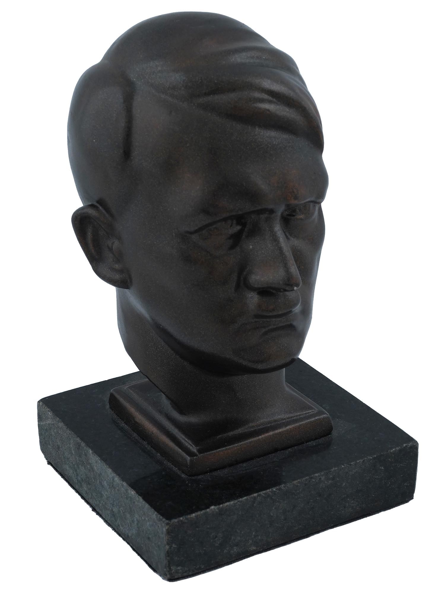 WWII GERMAN BUST OF ADOLF HITLER AFTER HANS RETZBACH: A WWII Nazi German Third Reich cast iron bust representing Adolph Hitler. The sculpture is mounted on a marble base. After an original artwork by Hans Retzbach, 1888 to 1960, a German sculptor. Adolf 