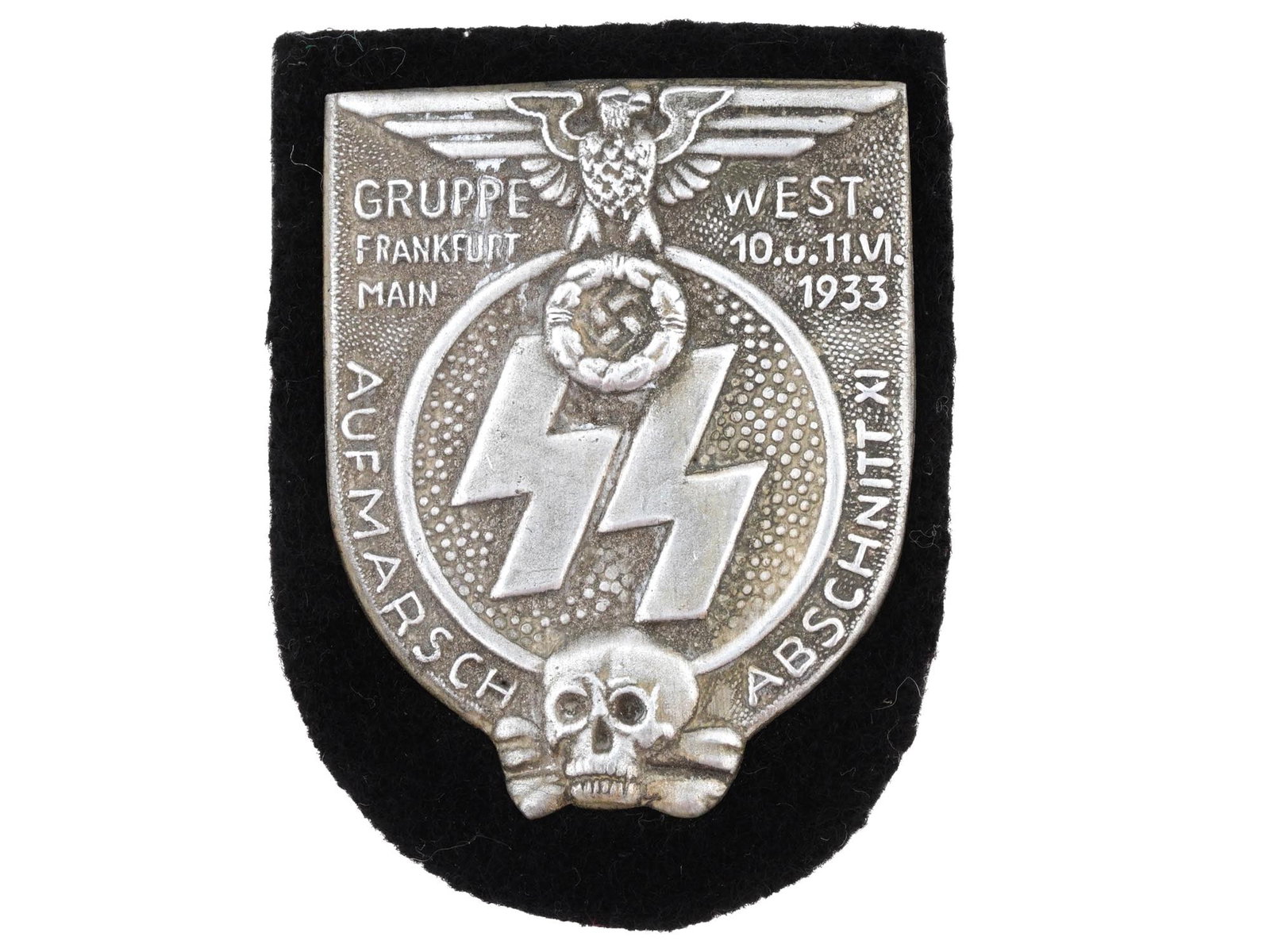 1933 TYPE WAFFEN SS GRUPPE WEST SHIELD: A WWII German Third Reich type Waffen SS division shield. The shield is inscribed, 1933 Gruppe West, features SS runes, Reichsadler Nazi eagle and Deaths Head Totenkopf scull insignias. Unmarked. WWII