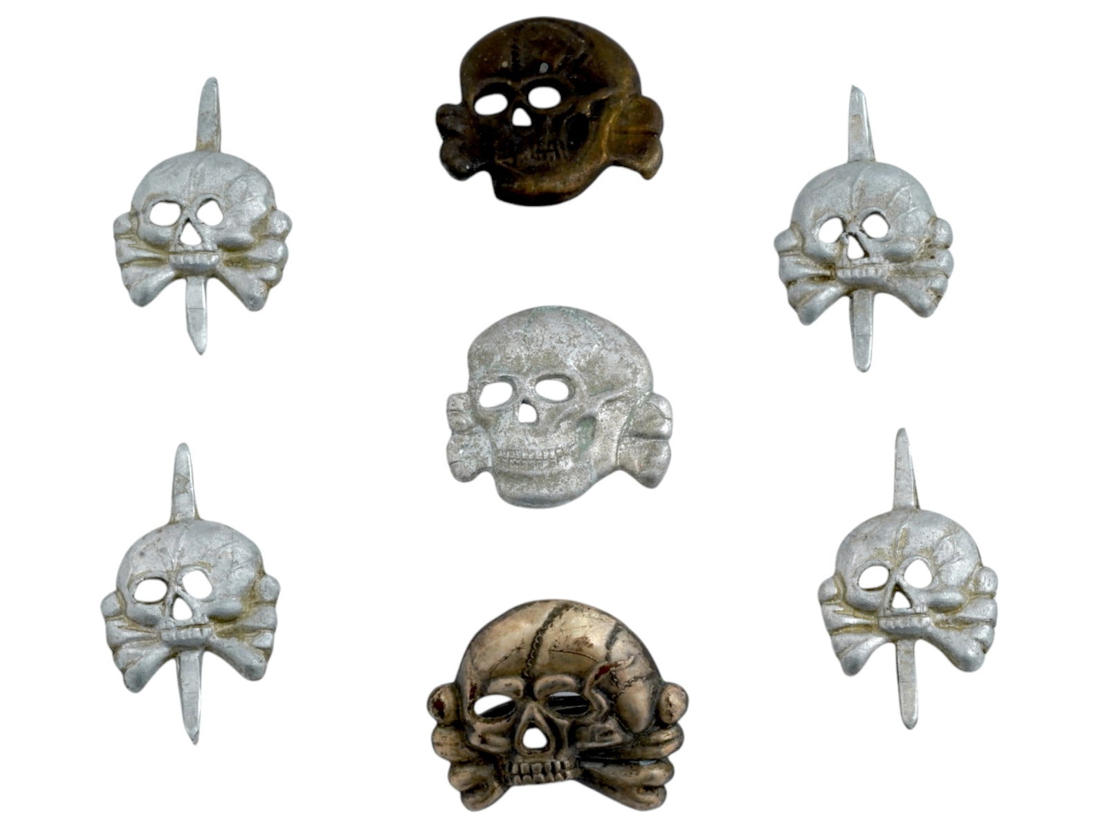 GROUP OF SEVEN GERMAN WWII TYPE TOTENKOPF COCKADES: A lot of seven World War II model Nazi German Totenkopf cockades or cap badges. Tank Division and Waffen SS types, the latter are marked RZM on the backside. Second World War Historical Collectables A