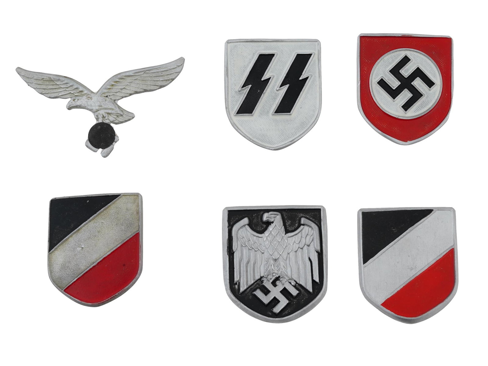 GROUP OF SIX GERMAN WWII MODEL HELMET SHIELDS: A lot of World War II type Nazi German enameled badges, shields for military helmets of the Afrika Korps. A total of three pairs. Luftwaffe Tropical, SS Tropical, Army Tropical. Second World War Histo