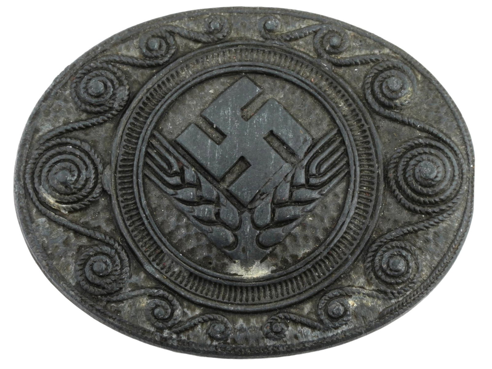 GERMAN WWII TYPE REICH LABOUR SERVICE WOMEN BADGE: A Second World War model RAD Reich Labour Service female branch zink badge. Marked on the backside: J.B.u Co. for Julius Bauer and Co. below the pin. Decorated with scrolled filigree motifs surroundin