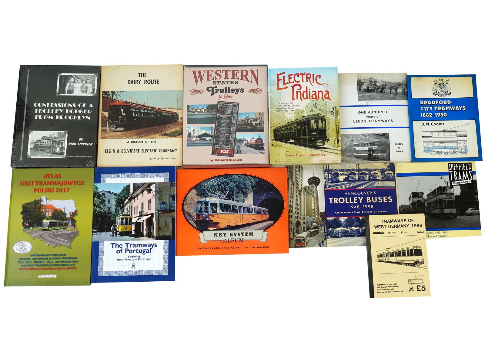 LOT AMERICAN EUROPEAN RAILWAY TRANSPORT ALBUMS BOOKS: A collection of twelve European, and American books and albums about transport. The collection includes Confessions of a Trolley Dodger From Brooklyn by Stan Fischler; The Dairy Route a History of The