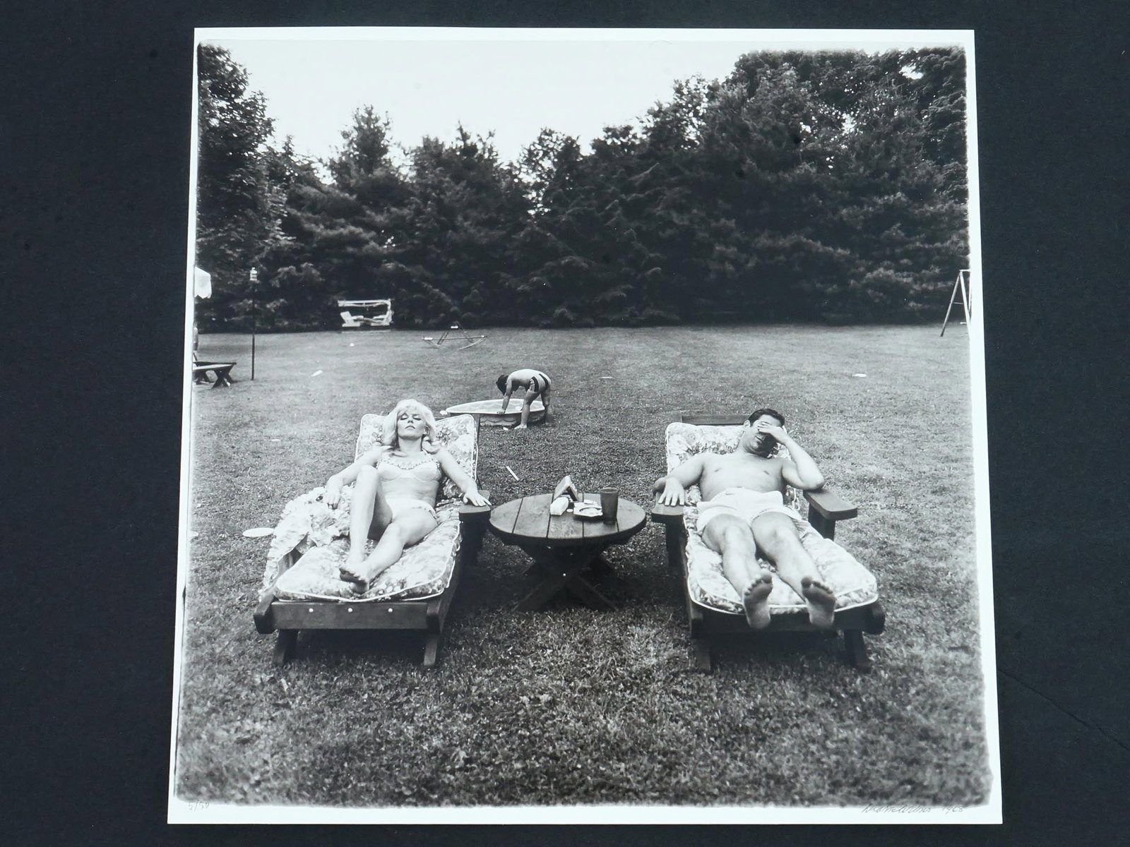 PHOTOGRAVURE AFTER DIANE ARBUS FAMILY ON LAWN 1968: After Diane Arbus, American, 1923 to 1971, a photogravure of the original print showing a family on their lawn one Sunday in Westchester, N.Y., 1968. Signed and dated lower right. Numbered 5 of 50 low