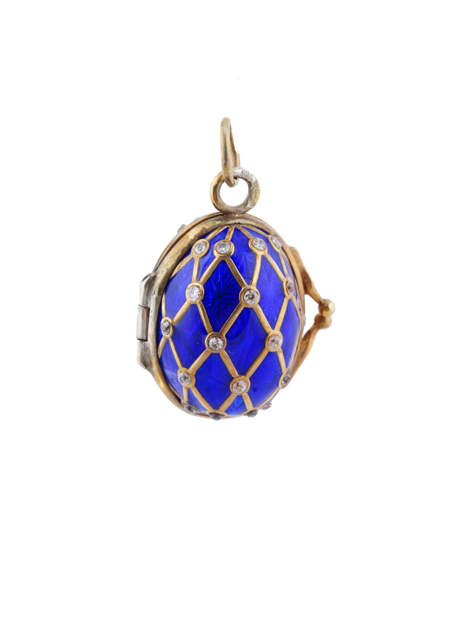 RUSSIAN GILT SILVER GUILLOCHE ENAMEL EGG LOCKET: A large Russian gilt silver egg-shaped locket pendant. The surface is covered with cobalt blue guilloche enamel and lozenge overlay garnished with diamonds. Hallmark of 88 silver standard and makers m