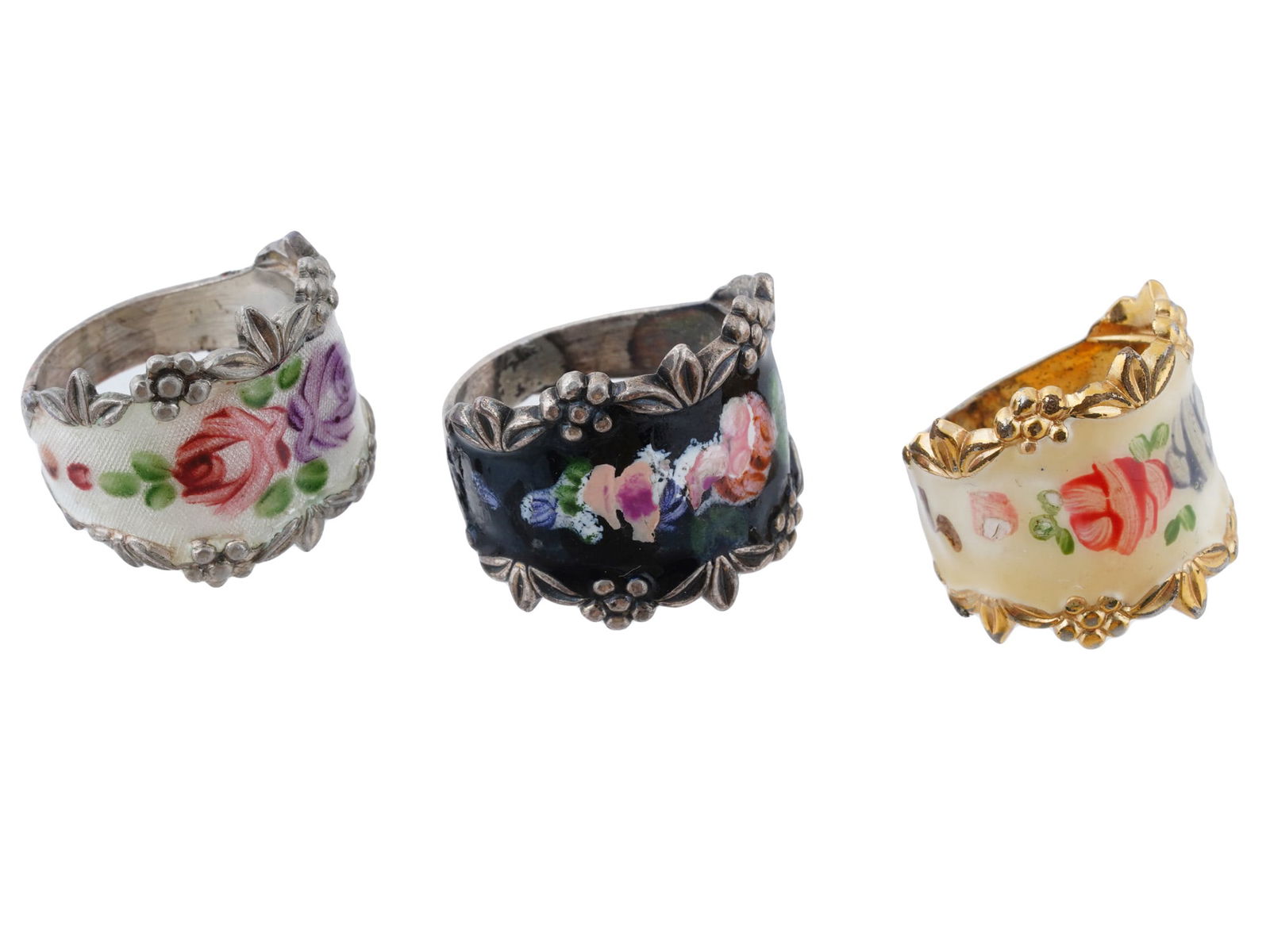 VINTAGE AMERICAN STERLING SILVER ENAMEL RINGS: A lot of three vintage American sterling silver rings with enameled floral decor. One ring with guilloche enamel, marked Sterling-ESPO. The second ring is gold-plated, marked 18K HGE V on the inside.
