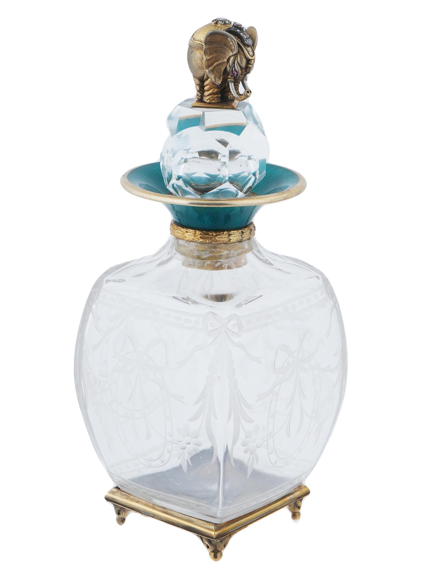 RUSSIAN GILT SILVER ENAMEL DIAMOND GLASS DECANTER: A Russian clear lead glass liquor decanter with gilt silver mount and feet. Rounded square body with etched ribbon ornaments. The neck borders are set with sea-green guilloche enamel. The faceted glob